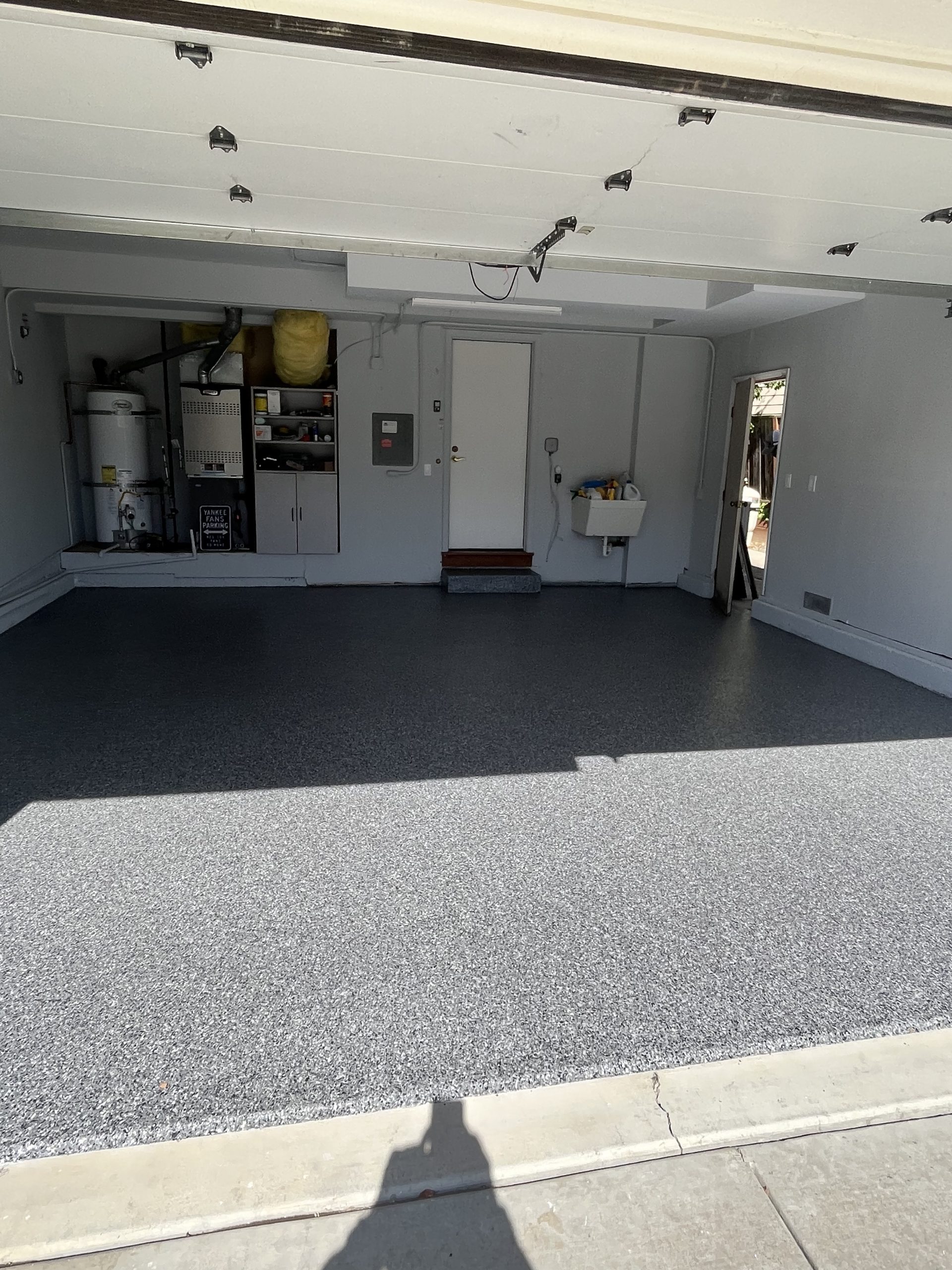 Dark gray vinyl chip epoxy garage floor coating in a clean two-car garage in Benicia, CA by J&C Concrete