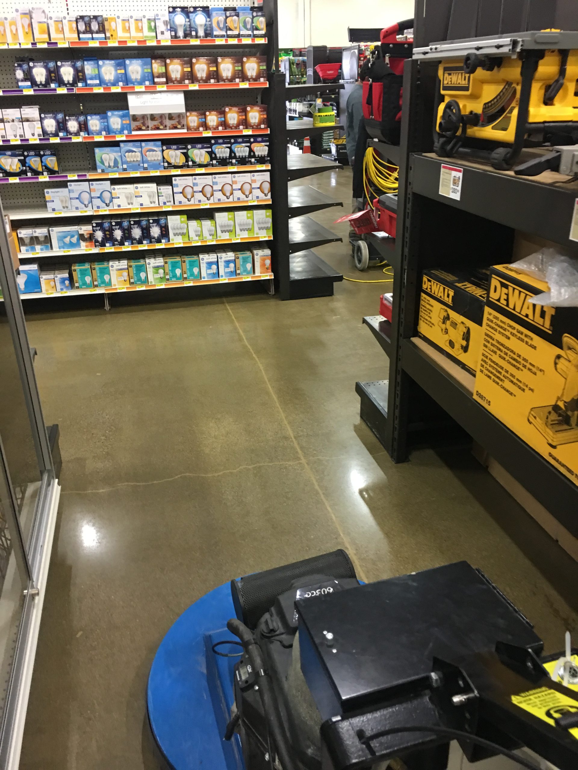 Concrete polishing machine working a retail store floor in Petaluma CA, producing a glossy polished concrete finish