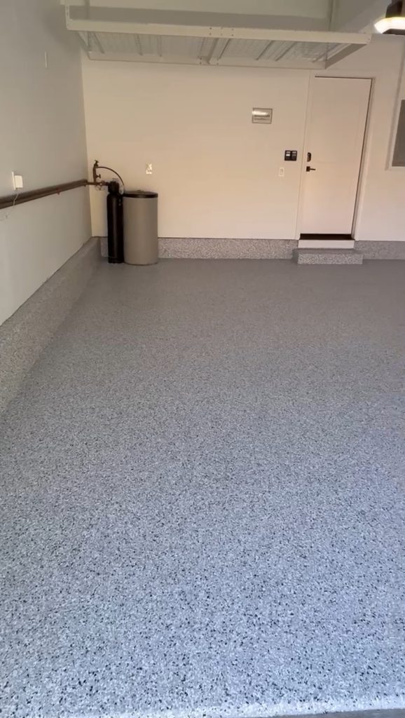 Clean residential garage with smooth gray speckled epoxy flake floor coating in a North Bay California home