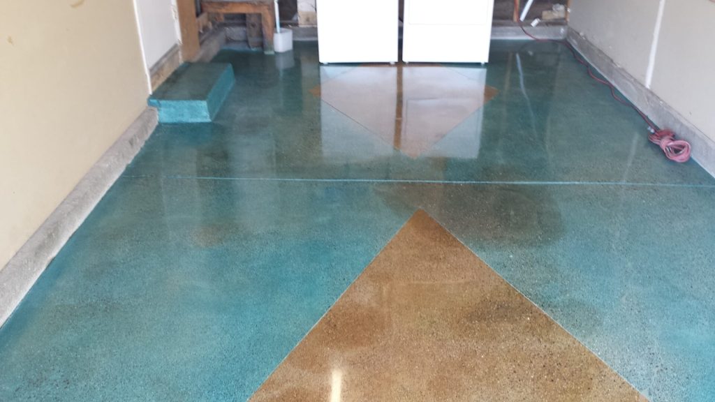 Polished concrete patio floor with teal and tan decorative acid stain colors in a California home