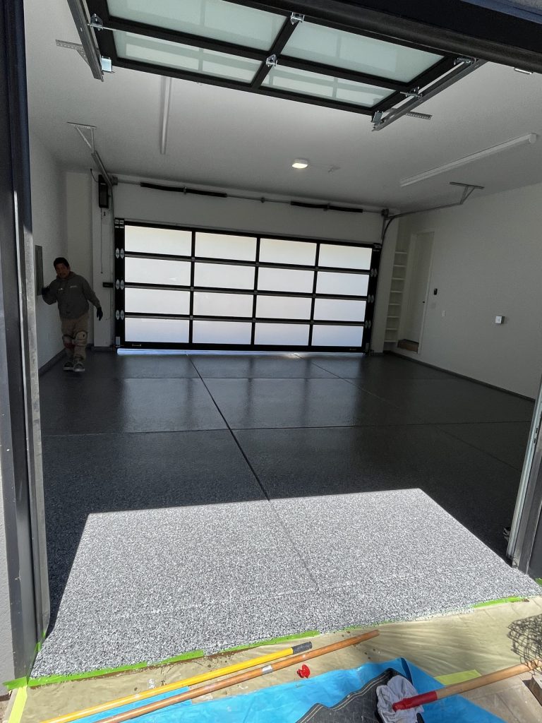Dark gray vinyl chip epoxy flake floor coating in a clean two-car garage, North Bay CA home