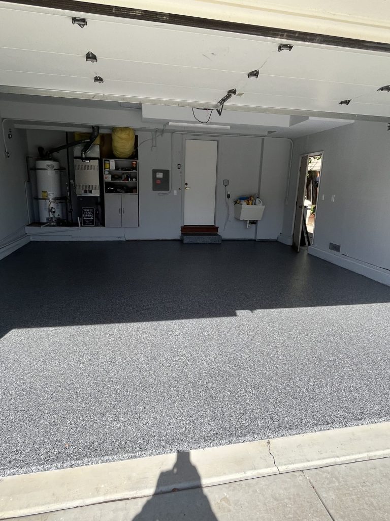 Dark gray vinyl chip epoxy garage floor coating in a two-car garage in Benicia, CA by J&C Concrete